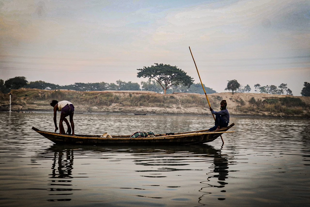 Two fishermen working on a river boat
